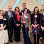 Lynn Crowder Greer stand with Orran Brown, Sr., Orran Brown, Jr., Kerry McLaughlin, Roma Petkauskas, Jessica Stankus Smith, Morgan Meador, and Bethany Anderson at the Virginia Lawyers Weekly Influential Women in Law 2026 Reception.